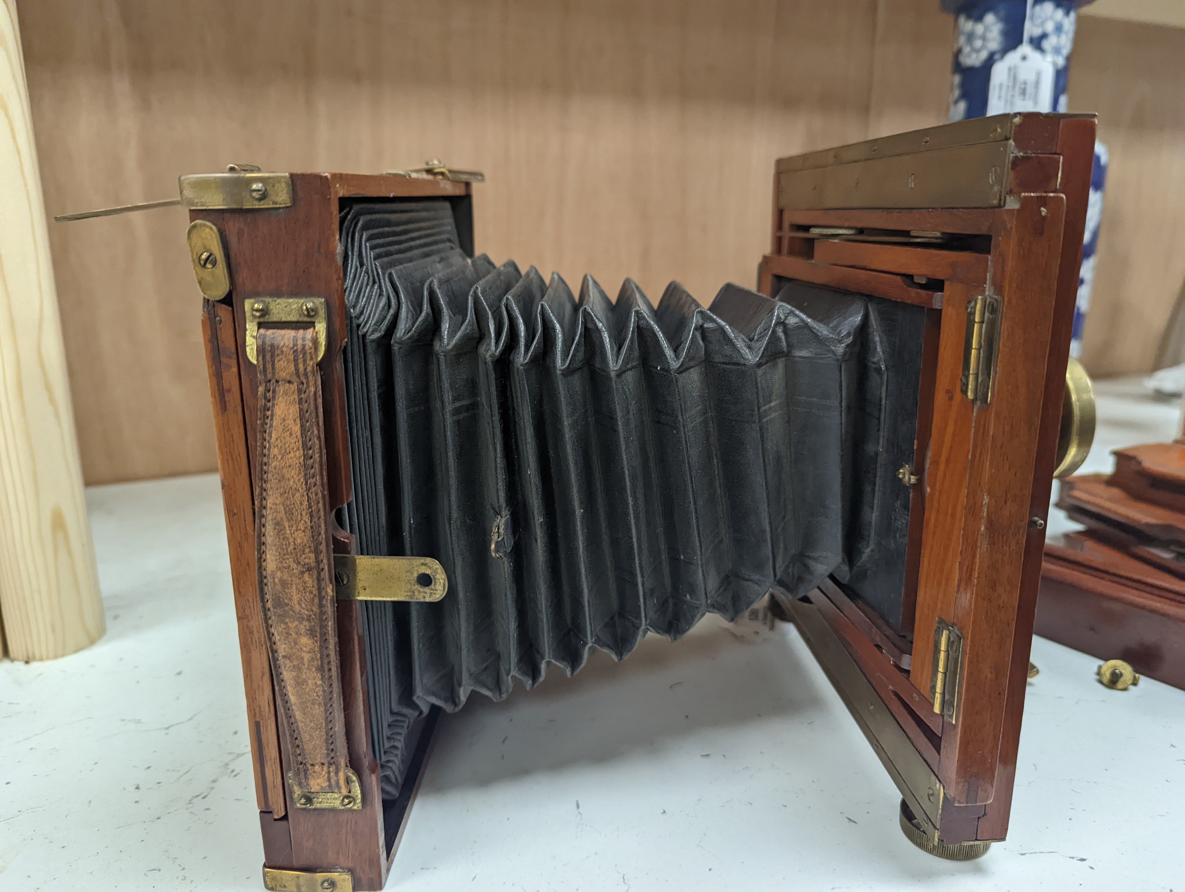 A Thornton Pickard mahogany and brass plate camera, three plates and a stand, 20cm sq.